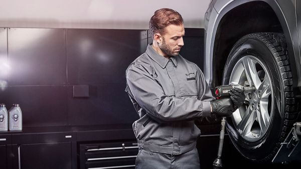 A Lexus mechanic working on a Lexus wheel