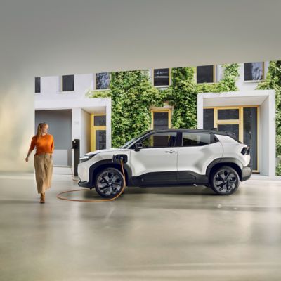 A family charges their Toyota bZ4X at a public charging station