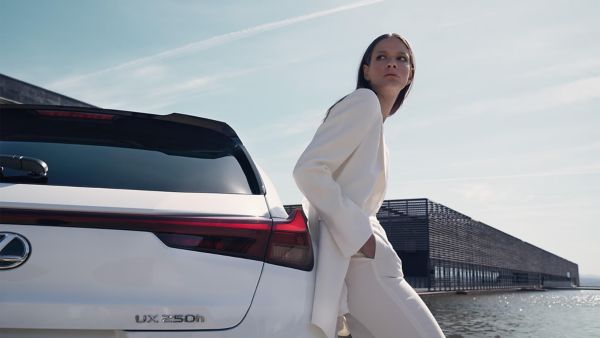 woman next to Lexus car