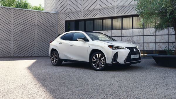 Biały Lexus stojący przed budynkiem