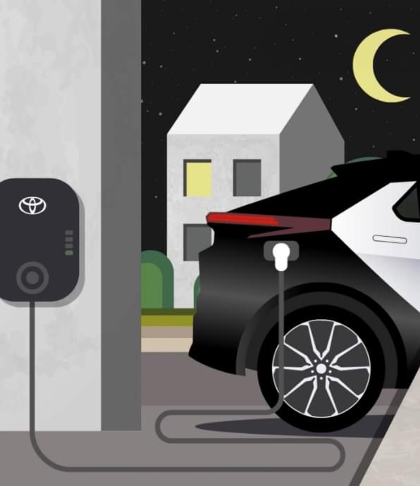 Grafika Toyoty podczas ładowania z gniazdka nocą.
