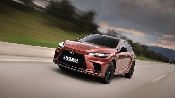 Front view of the Lexus RX 450h+ driving over a bridge