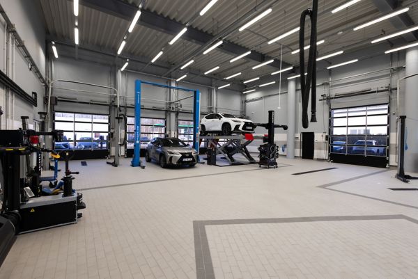 A Lexus mechanic mechanic checking a vehicles oil
