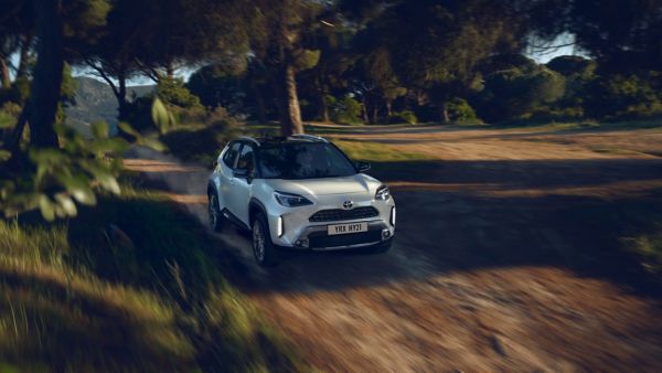 Toyota Yaris Cross driving along a dirt road